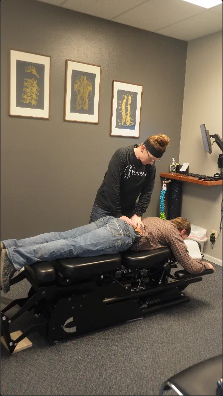 Dr. Whipple providing a chiropractic adjustment during an office visit