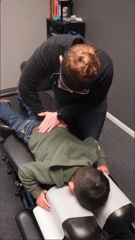 Dr. Whipple providing a chiropractic adjustment during a patient visit