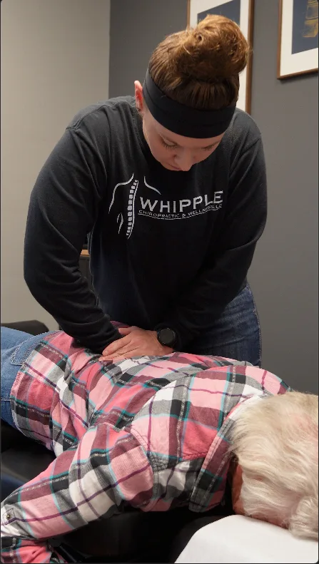 Dr. Whipple providing hands-on chiropractic care to a patient